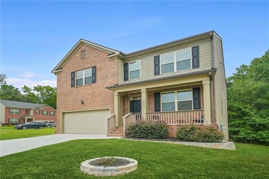 Craftsman inspired home featuring a front lawn, a porch, concrete driveway, and an attached garage