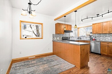Kitchen with black range with gas stovetop, kitche