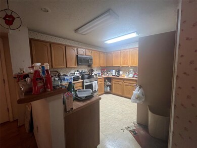 Kitchen featuring light brown cabinetry, a texture