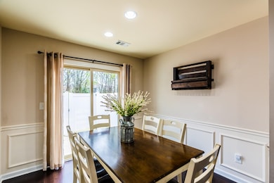 Dining area has a pantry, wainscoting and patio doors leading out to a private patio. 