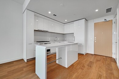 Kitchen with white cabinets, visible vents, and m