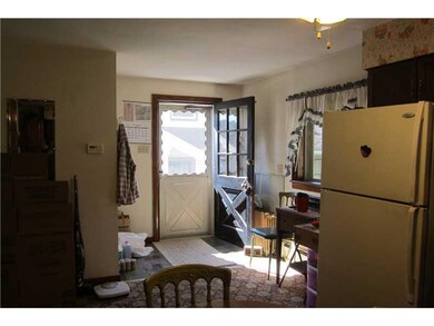 Kitchen. Door in kitchen leads to a small side por