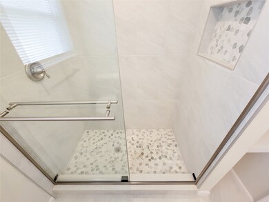 new shower with beautiful pebble design