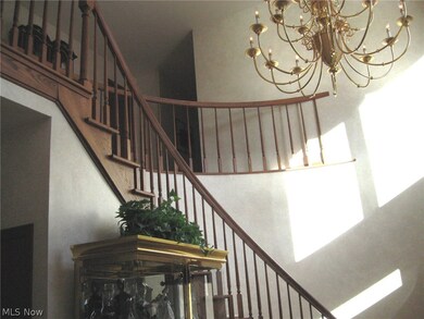 The inviting foyer with a spiral staircase.