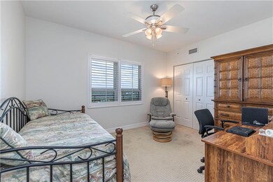Bedroom with carpet, an office area, a closet, baseboards, and ceiling fan