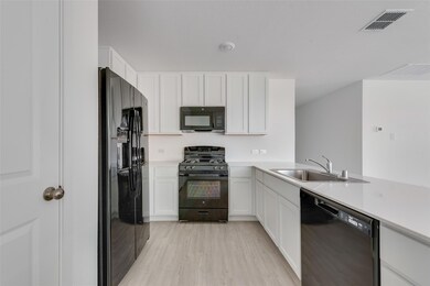 Kitchen featuring black appliances, kitchen penins