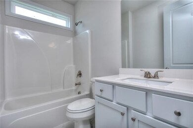 Full bath featuring toilet, vanity, and shower / b