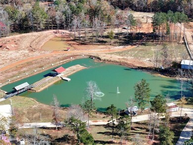 View of property location with a large body of water and a tree filled landscape