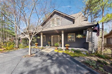 View of front of home with a porch and a shingled roof