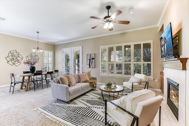 Living area featuring crown molding, a chandelier