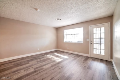 Empty room featuring visible vents, baseboards, an