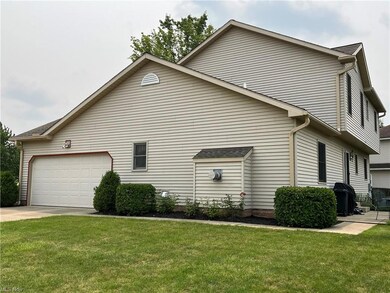Side view showing the 2 car garage and back of fireplace.