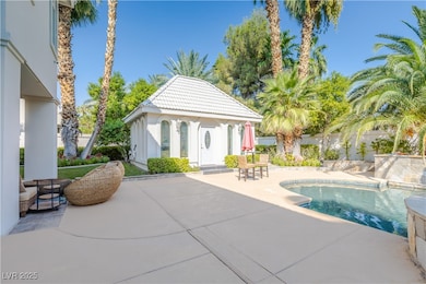 Pool with a patio, an outdoor structure, and fence