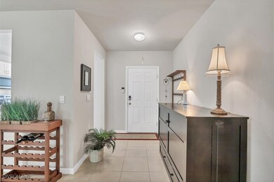 Foyer entrance with light tile patterned flooring
