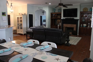 Dining area with ceiling fan, a high end fireplac