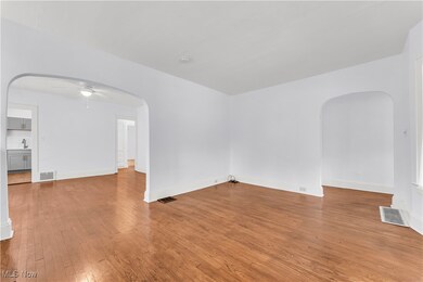 Empty room with ceiling fan and wood-type flooring