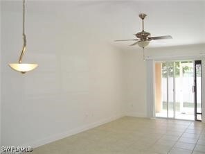 Unfurnished room with light tile patterned floors and ceiling fan