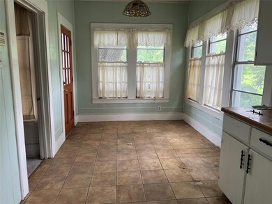 Unfurnished dining area with tile floors and a wea