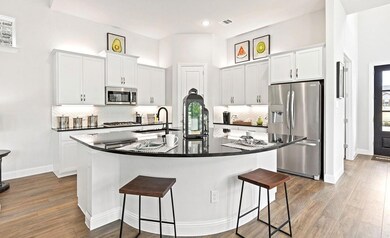 Kitchen featuring sink, white cabinets, a kitchen 