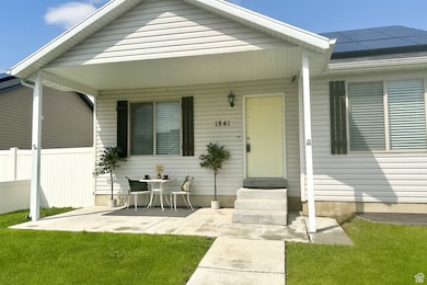 Doorway to property with solar panels and covered porch
