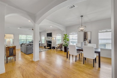 Dining space with a fireplace, ceiling fan, light