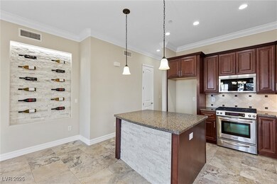Kitchen with decorative light fixtures, stainless
