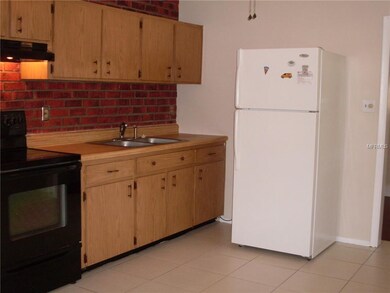 Tile flooring and ceiling fan in kitchen.