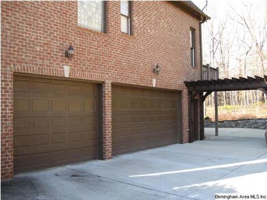 3 car lower level garage with pergola