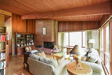 dramatic brick fireplace and wood ceilings through