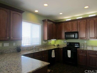 Kitchen with granite counters.  Window looks into 