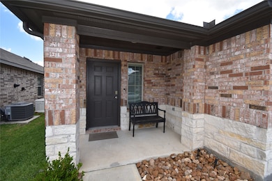This welcoming front porch with a mix of brick and