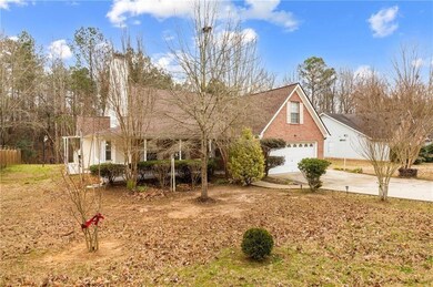 View of front of house with concrete driveway, a garage, and brick siding