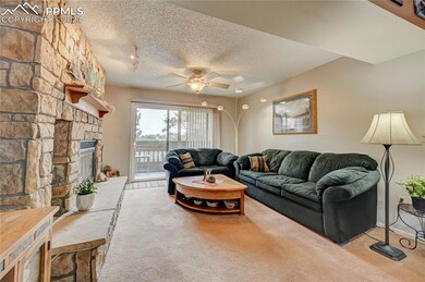 Carpeted living room featuring a textured ceiling,