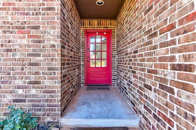 Doorway to property with brick siding