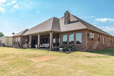 Rear view of property featuring central AC unit, a