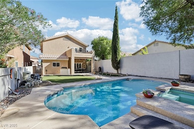 View of pool featuring a balcony, a fenced backyard, a patio area, and a pool with connected hot tub
