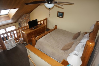 Bedroom with wood ceiling, ceiling fan, carpet flo