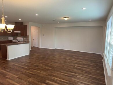 Kitchen with dark wood-style floors, white applia