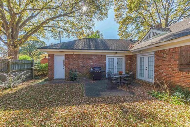 Back of property with a patio area and french door