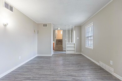 Unfurnished living room featuring hardwood / wood-