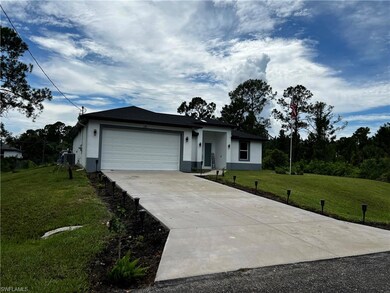 Single story home with stucco siding, driveway, co