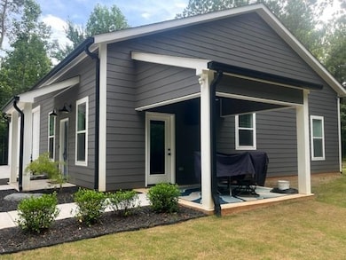 Back of property with a yard and a patio area