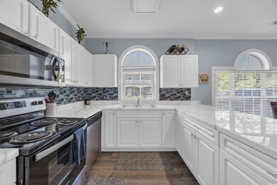 Kitchen with white cabinets, stainless steel appli