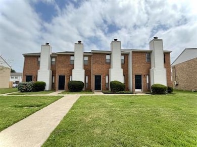 Multi unit property featuring brick siding and a f