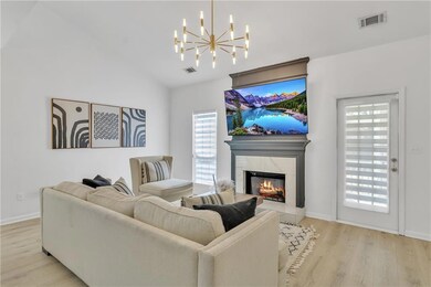 Living area featuring visible vents, an inviting c