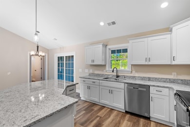 Kitchen featuring decorative light fixtures, white