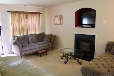 Open family space with gas fireplace and TV nook