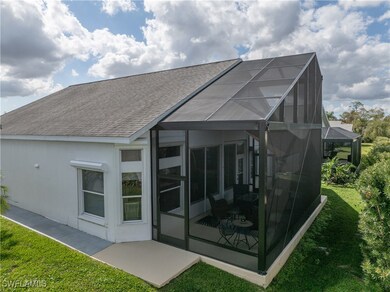 Rear view of property featuring a lanai, a patio a