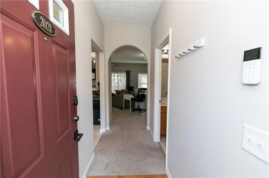Corridor featuring arched walkways, light colored 