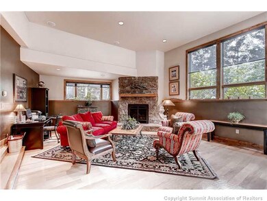 Living Room. The sunken living room is large enough for the holiday gathering around the fireplace or just enjoy warming up after the day on the slopes.
